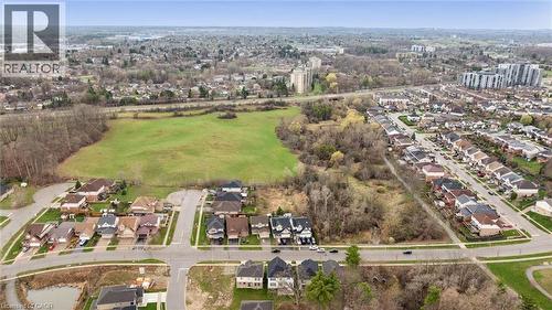 Aerial perspective showcasing an expansive green field bordered by residential streets with detached homes - 213 Fallowfield Drive, Kitchener, ON - Outdoor With View