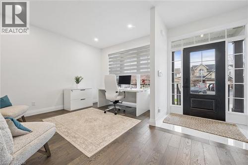 Entryway with dark wood-finish flooring featuring an opaque panel front door with sidelights and transom windows - 213 Fallowfield Drive, Kitchener, ON - Indoor Photo Showing Office