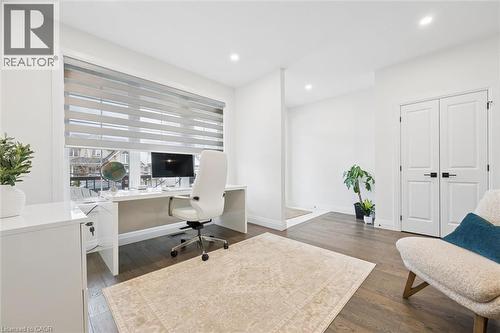 Bright room featuring wood-finish flooring, recessed lighting, and a wide window with horizontal blinds - 213 Fallowfield Drive, Kitchener, ON - Indoor Photo Showing Office