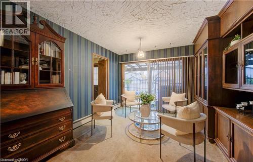 This interior space features striped wallpaper, a textured ceiling, and carpeted flooring - 48 Dupont Street, Waterloo, ON - Indoor