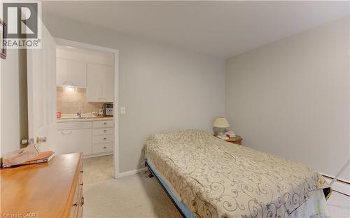 This room offers a versatile layout with light-colored walls and carpeted flooring - 48 Dupont Street, Waterloo, ON - Indoor Photo Showing Bedroom