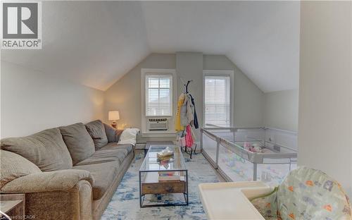 This room features two windows with blinds, a sloped ceiling, and light-colored walls - 48 Dupont Street, Waterloo, ON - Indoor Photo Showing Living Room