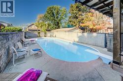 The property features a private swimming pool with a diving board, surrounded by a concrete patio - 