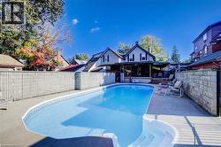 The property features a large outdoor swimming pool with an integrated spa area and a surrounding concrete patio - 