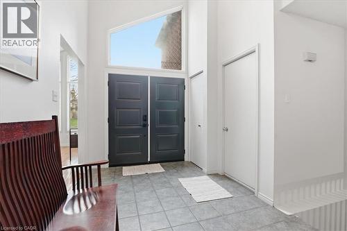 Inviting entryway featuring a tall ceiling, tiled flooring, double doors, and an overhead transom window - 110 Milton Avenue, Cambridge, ON - Indoor Photo Showing Other Room