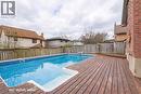 Outdoor swimming pool with a surrounding wooden deck and brick exterior - 110 Milton Avenue, Cambridge, ON  - Outdoor With Above Ground Pool 