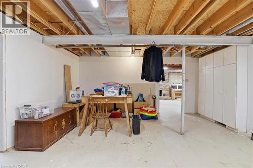 The property features an unfinished basement with white walls, exposed ceiling joists, and a concrete floor - 110 Milton Avenue, Cambridge, ON - Indoor Photo Showing Basement