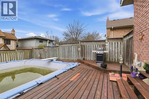 The property features a private backyard with a spacious wooden deck - 110 Milton Avenue, Cambridge, ON - Outdoor With Exterior