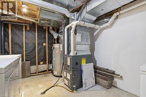Utility area featuring a water heater, furnace, and exposed ductwork - 110 Milton Avenue, Cambridge, ON - Indoor Photo Showing Basement