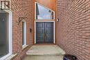 The property features a brick exterior with a prominent double door entrance, complemented by an angular transom window - 110 Milton Avenue, Cambridge, ON  - Outdoor With Exterior 