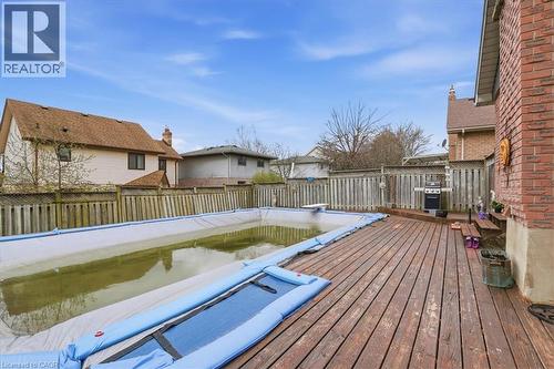 The property features an outdoor swimming pool, a wooden deck, and a brick exterior - 110 Milton Avenue, Cambridge, ON - Outdoor