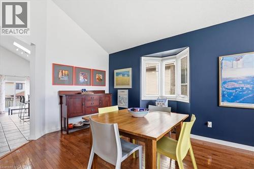 This dining area features hardwood floors and a bay window, with a vaulted ceiling and a skylight in the adjacent space - 110 Milton Avenue, Cambridge, ON - Indoor Photo Showing Dining Room