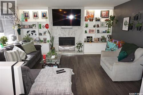 91 Plant Crescent, Regina, SK - Indoor Photo Showing Living Room With Fireplace