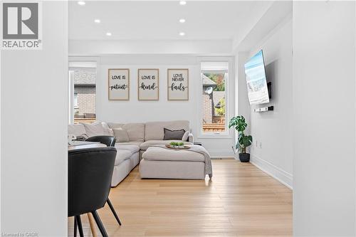 Bright open-concept living area featuring light wood-finish flooring, recessed lighting, and crisp white walls - 1026 Wright Drive, Midland, ON - Indoor Photo Showing Living Room