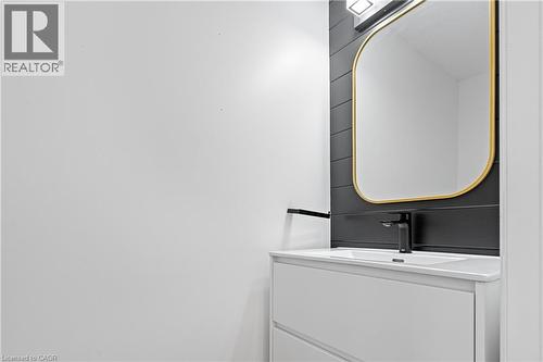 White floating vanity with integrated sink and matte black faucet - 1026 Wright Drive, Midland, ON - Indoor Photo Showing Laundry Room