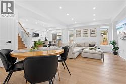 Bright open-concept living space with light wood-finish flooring - 