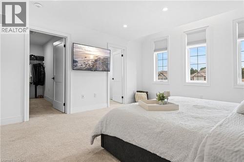 Carpeted bedroom with three windows featuring horizontal blinds - 1026 Wright Drive, Midland, ON - Indoor Photo Showing Bedroom