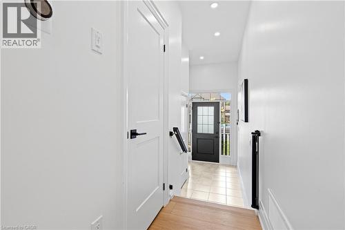 Bright entryway featuring a dark-paneled door with glass inserts, recessed lighting, and tile flooring - 1026 Wright Drive, Midland, ON - Indoor Photo Showing Other Room
