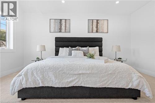 Spacious bedroom with light-toned carpet flooring and bright white walls - 1026 Wright Drive, Midland, ON - Indoor Photo Showing Bedroom