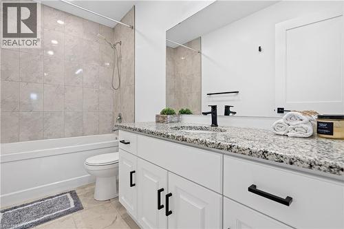 Bathroom featuring a white vanity with granite countertop, black fixtures, and a shower-tub combination with tile surround - 1026 Wright Drive, Midland, ON - Indoor Photo Showing Bathroom