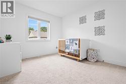 Bright interior room with white walls and light-toned carpeting - 