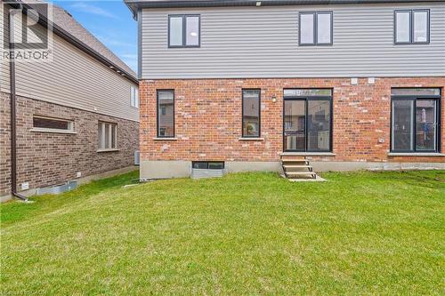 Expansive green lawn with a two-story exterior featuring a brick first level and horizontal siding on the second - 1026 Wright Drive, Midland, ON - Outdoor With Exterior