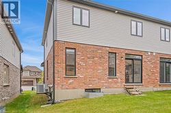 Brick and siding exterior featuring multiple windows and sliding glass doors - 