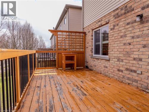 The property features an exterior deck with a wooden surface, a wooden railing with black balusters, and a wooden privacy screen - 338 Maverick Street, Waterloo, ON - Outdoor With Deck Patio Veranda With Exterior