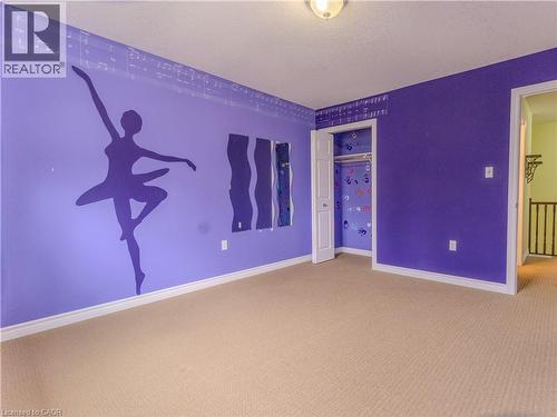 This room features carpeted flooring and walls painted in shades of purple - 338 Maverick Street, Waterloo, ON - Indoor