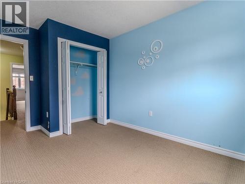 Carpeted room featuring light blue and dark blue painted walls - 338 Maverick Street, Waterloo, ON - Indoor Photo Showing Other Room