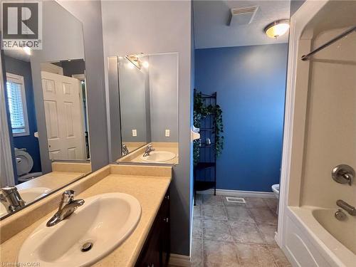 Bathroom featuring a bathtub, a vanity with a white sink, and tiled flooring - 338 Maverick Street, Waterloo, ON - Indoor Photo Showing Bathroom