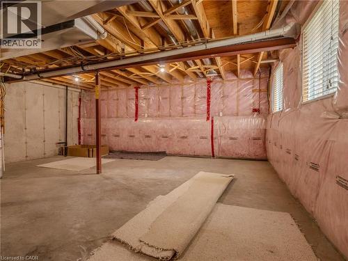 The property features an unfinished basement with exposed wooden joists, concrete flooring, and insulated walls - 338 Maverick Street, Waterloo, ON - Indoor Photo Showing Basement