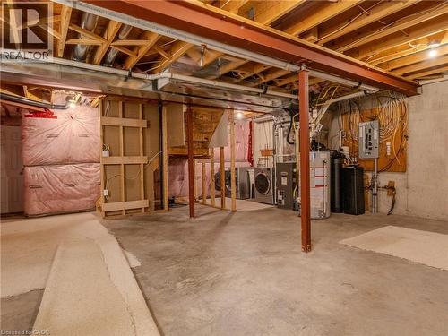 The property features an unfinished basement with exposed wooden beams, a concrete floor, and visible insulation - 338 Maverick Street, Waterloo, ON - Indoor Photo Showing Basement