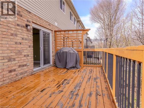 The property features an outdoor wooden deck with a wooden lattice privacy screen and black metal railings - 338 Maverick Street, Waterloo, ON - Outdoor With Deck Patio Veranda With Exterior