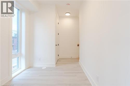 This bright interior space features light-toned flooring and white walls, creating an airy atmosphere - 144 Everett Common, St. Catharines, ON - Indoor Photo Showing Other Room