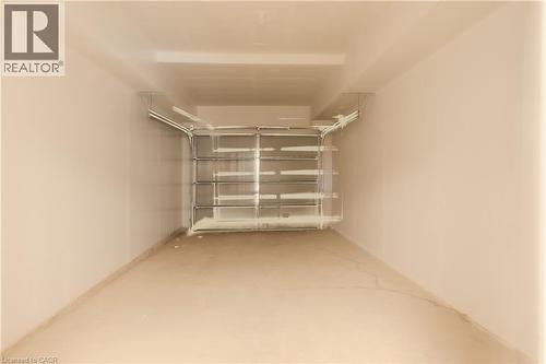 Spacious garage with a concrete floor and a garage door - 144 Everett Common, St. Catharines, ON - Indoor
