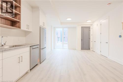 Open concept living space featuring light-colored flooring, white walls, and recessed lighting - 144 Everett Common, St. Catharines, ON - Indoor Photo Showing Kitchen