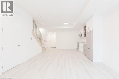 Bright and airy open-concept living area with light-toned flooring - 144 Everett Common, St. Catharines, ON - Indoor Photo Showing Other Room