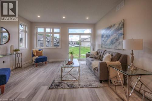 Spacious living area featuring light-toned walls, recessed lighting, and wood-finish flooring - 48 Main Street E, Innerkip, ON - Indoor Photo Showing Living Room