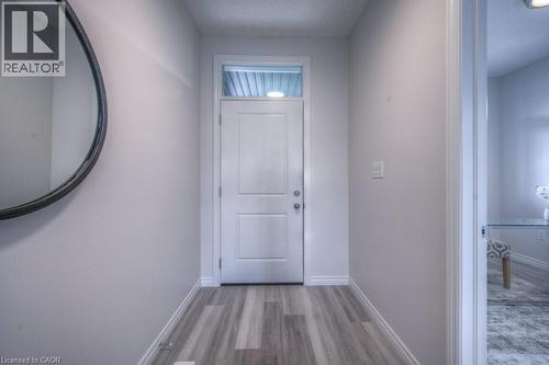 Entryway featuring wood-finish flooring, light grey wall paint, and white trim - 48 Main Street E, Innerkip, ON - Indoor Photo Showing Other Room