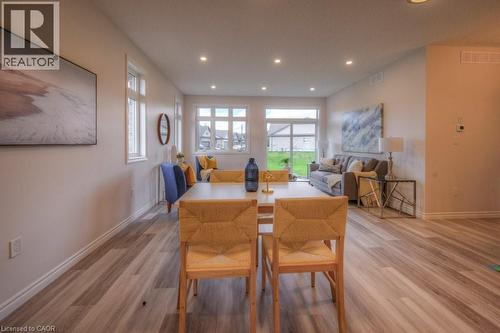 Spacious open-concept living area featuring wood-finish flooring, recessed lighting, and ample natural light from multiple windows - 48 Main Street E, Innerkip, ON - Indoor Photo Showing Office