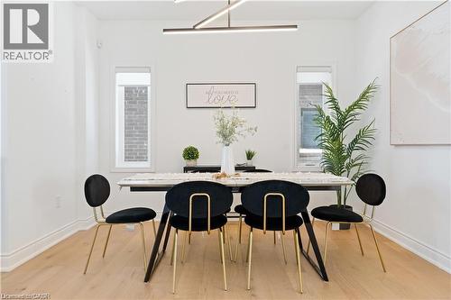 Dining area featuring light wood-style flooring and baseboards - 66 Cesar Place, Ancaster, ON - Indoor Photo Showing Dining Room
