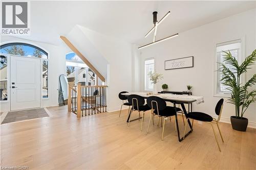 Dining room featuring light wood-type flooring and baseboards - 66 Cesar Place, Ancaster, ON - Indoor