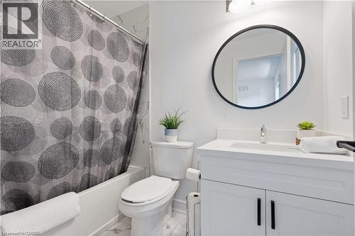 Bathroom featuring vanity and shower / bathtub combination with curtain - 66 Cesar Place, Ancaster, ON - Indoor Photo Showing Bathroom