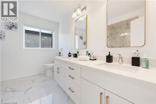 Full bathroom featuring a marble finish shower, double vanity, and light marble finish floors - 66 Cesar Place, Ancaster, ON - Indoor Photo Showing Bathroom