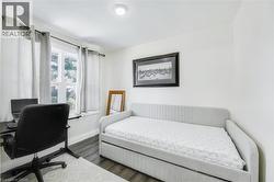 Room featuring a single window, recessed lighting, and wood-finish flooring - 