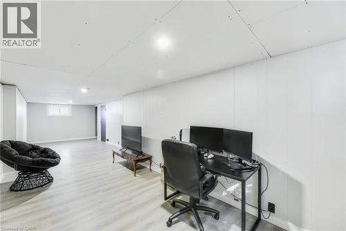 Spacious room featuring light wood-finish flooring, white paneled walls, recessed lighting, and a white ceiling - 18 Tweedsmuir Avenue, London, ON - Indoor