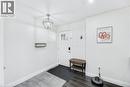 Entryway featuring a white paneled door with glass inserts, a contemporary spherical pendant light, and two-tone wood-finish flooring - 18 Tweedsmuir Avenue, London, ON  - Indoor Photo Showing Other Room 