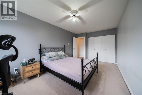 Carpeted room with a ceiling fan light fixture - 391 Pioneer Drive Unit# 4, Kitchener, ON - Indoor Photo Showing Bedroom