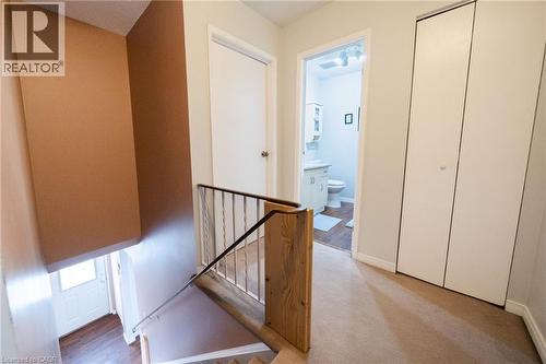 Carpeted hallway with painted walls and white trim - 391 Pioneer Drive Unit# 4, Kitchener, ON - Indoor Photo Showing Other Room